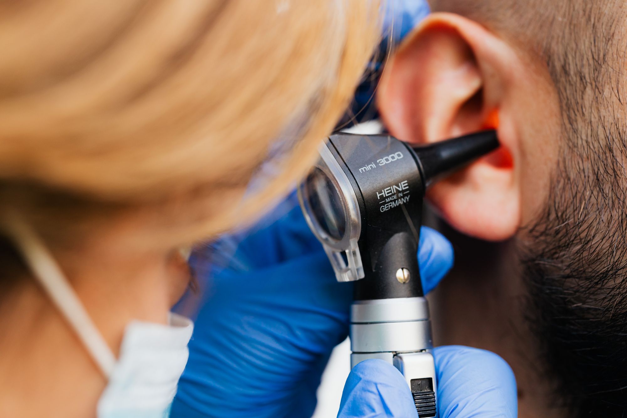Close-up of an ear examination with an otoscope